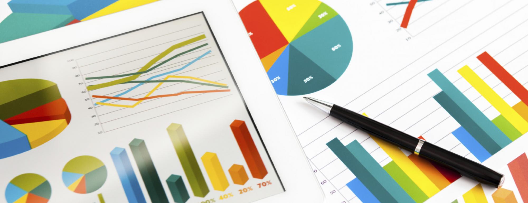 A tabletop covered in charts and graphs