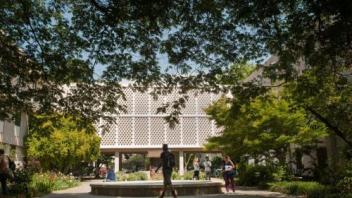 Voorhies Hall as seen through a veil of trees on a sunny day