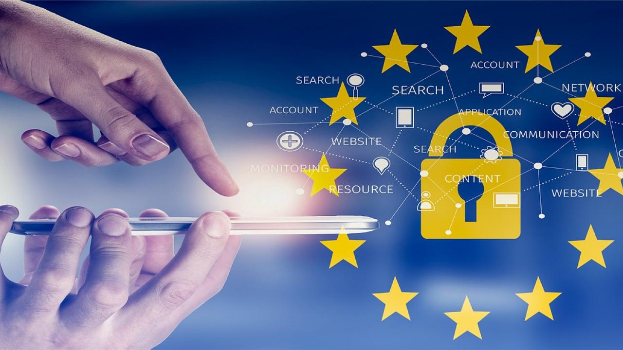 The General Data Protection Regulation logo overlaying a person touching a smart phone screen.