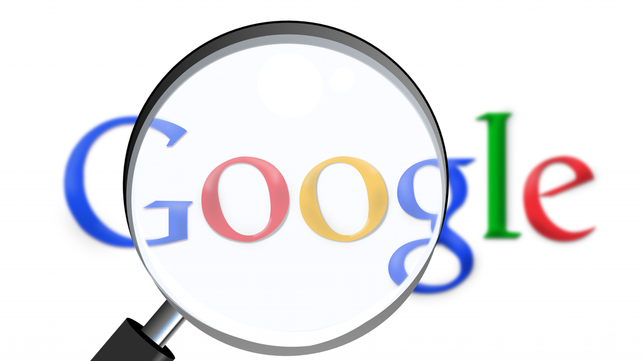 The Google logo with a magnifying glass in front of it.