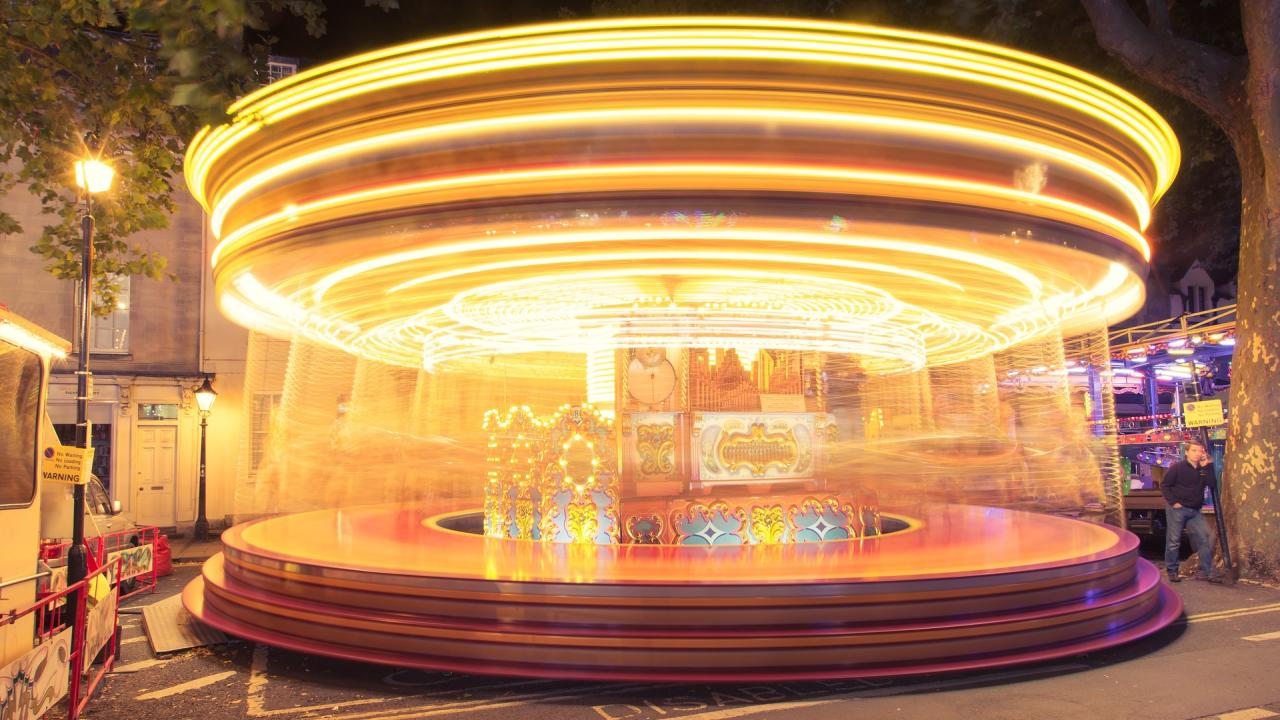 A time-lapse photo of a merry-go-round that makes it motion look like a whirling blur.