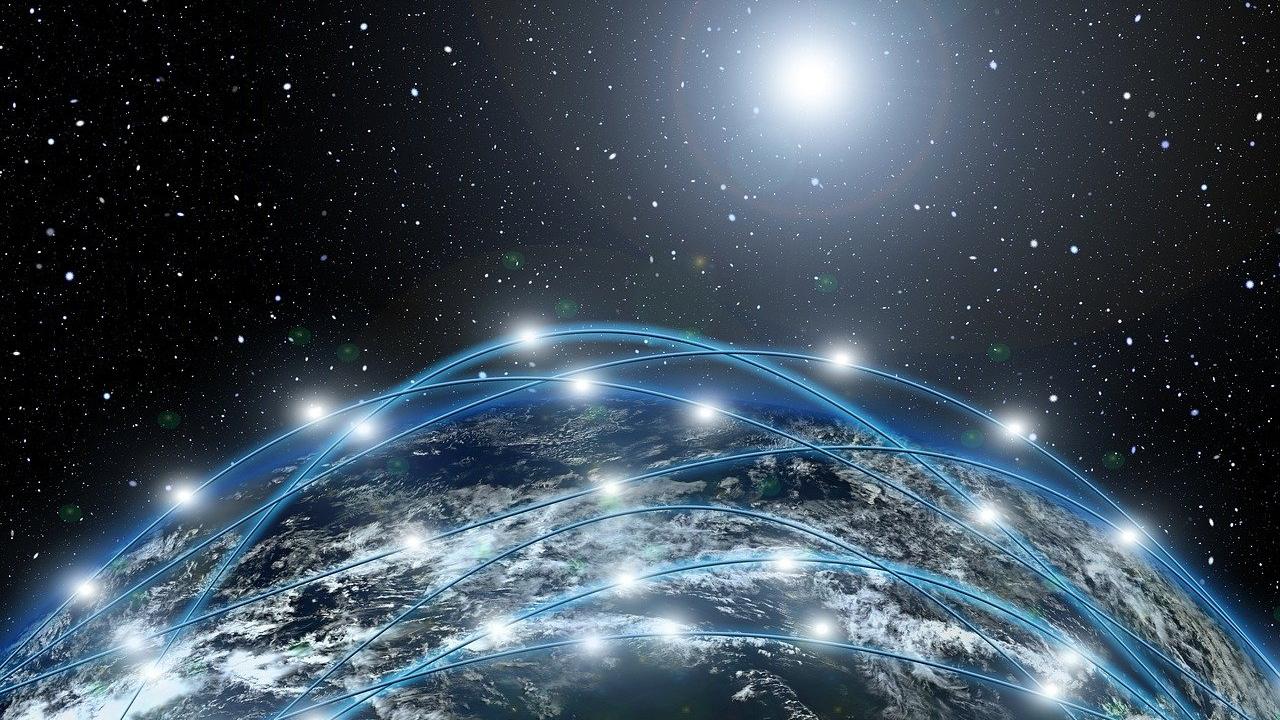Image of a view of Earth overlaid with a web of lines forming a visual network of connections.