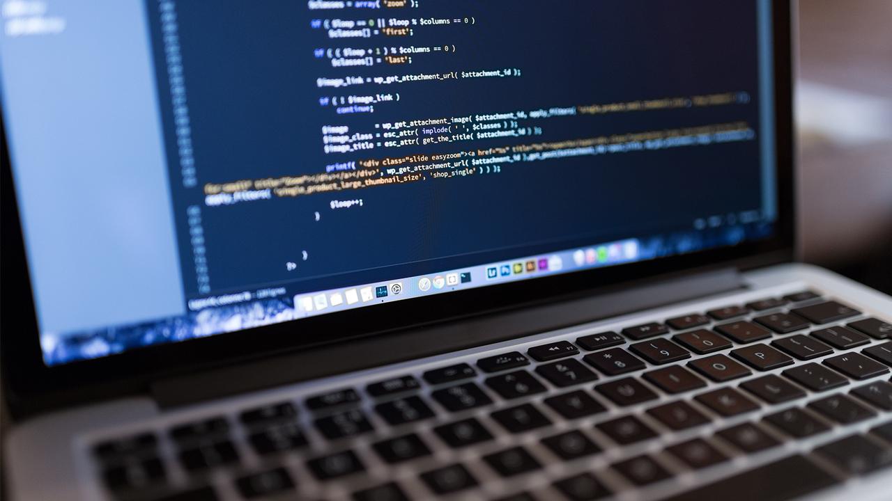 A laptop screen displaying programming code.