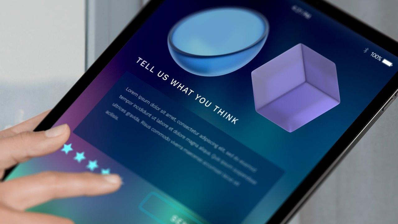 A tablet shows options for a likert five star rating system with a person's fingers selecting their preference