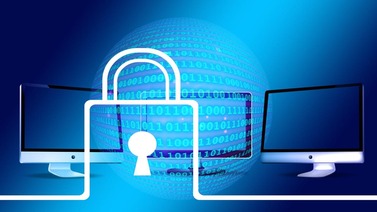 An illustration showing an outline of a white padlock superimposed over three computer monitors with a gradient blue background.