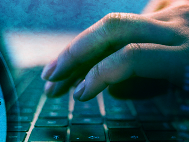 closeup of camera lens, laptop keyboard and computer screen displaying CSS