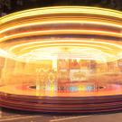 A time-lapse photo of a merry-go-round that makes it motion look like a whirling blur.