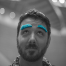 Dusty Boeger in black and white photography with thick blue comical eyebrows.