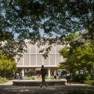Voorhies Hall as seen through a veil of trees on a sunny day
