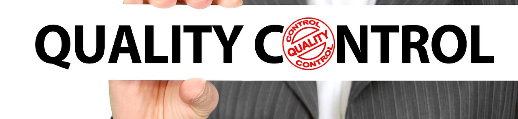 A woman in a business suit holding a sign reading "Quality Control"
