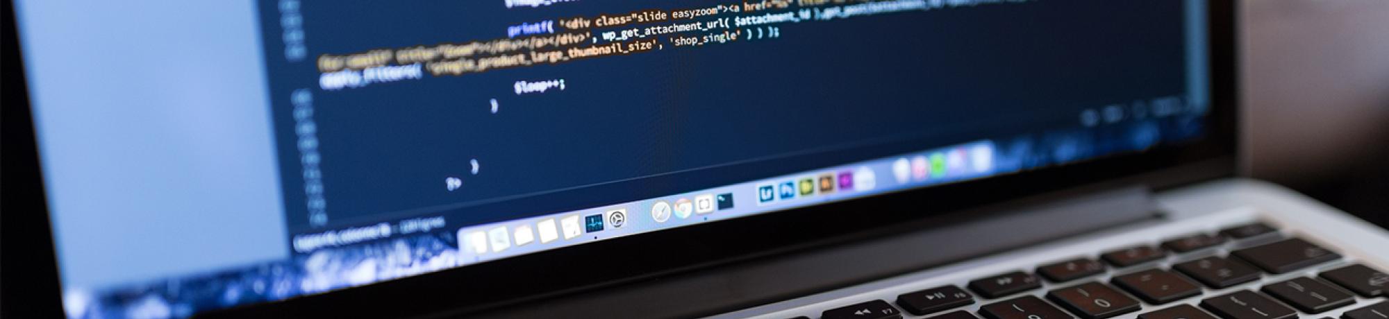 A laptop screen displaying programming code.